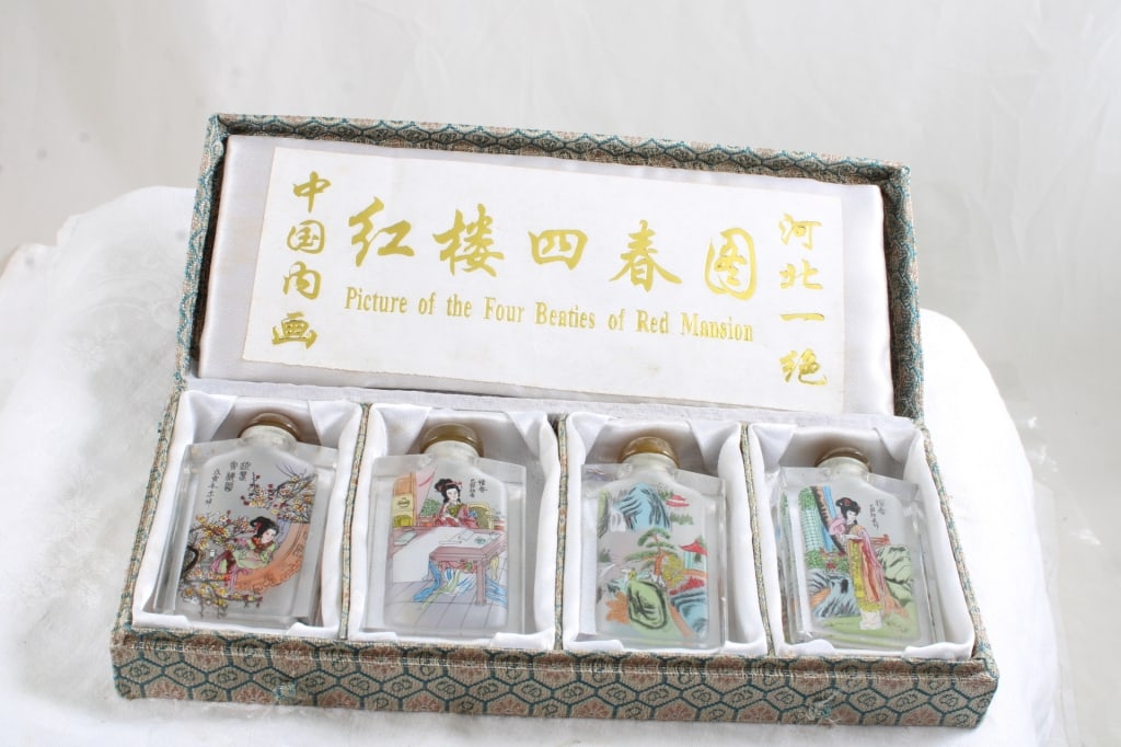 Picture the Four Beauties Red Mansion Perfumes: Picture the Four Beauties Red Mansion Perfumes - Encased in original Oriental Cloth Box. As pictured. Please read terms and conditions and askquestions before bidding. Live Auctioneers only shows 20 p