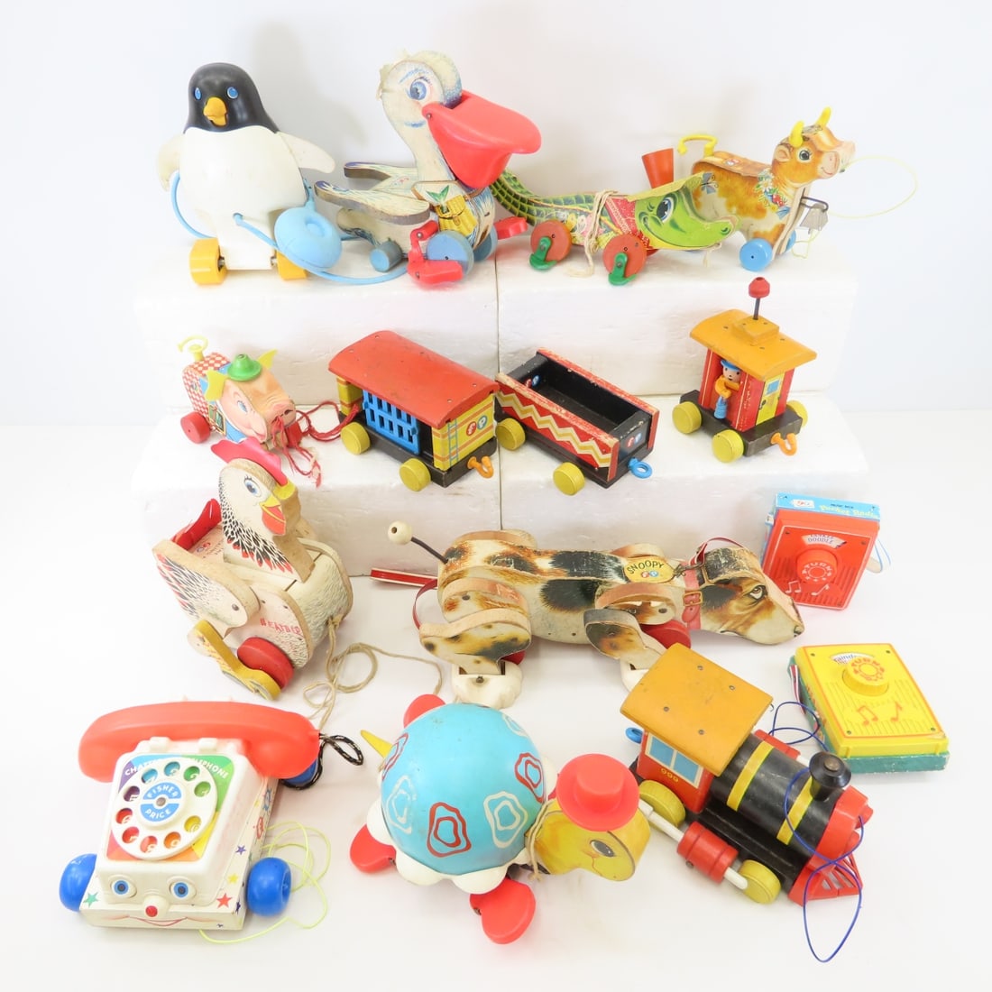 Vintage Fisher Price Pull Toys, Pelican & more: Vintage Fisher Price Pull Toys, Pelican & more - Pelican, Cackling Hen, telephone, Turtle, Pig, Penguin, Train, Puppy, 2 Radios & more Photos are part of the description. Live Auctioneers only shows 2