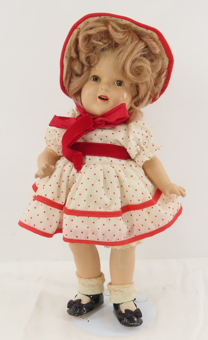 Vintage 14" Shirley Temple Look-A -Like Compo Doll: Vintage 14" Shirley Temple Look-A -Like Compo Doll - unmarked compo doll, sleep eyes with lashes, open mouth with teeth, red polka dot dress and bonnet, some compo cracks and crazing, with stand Photo