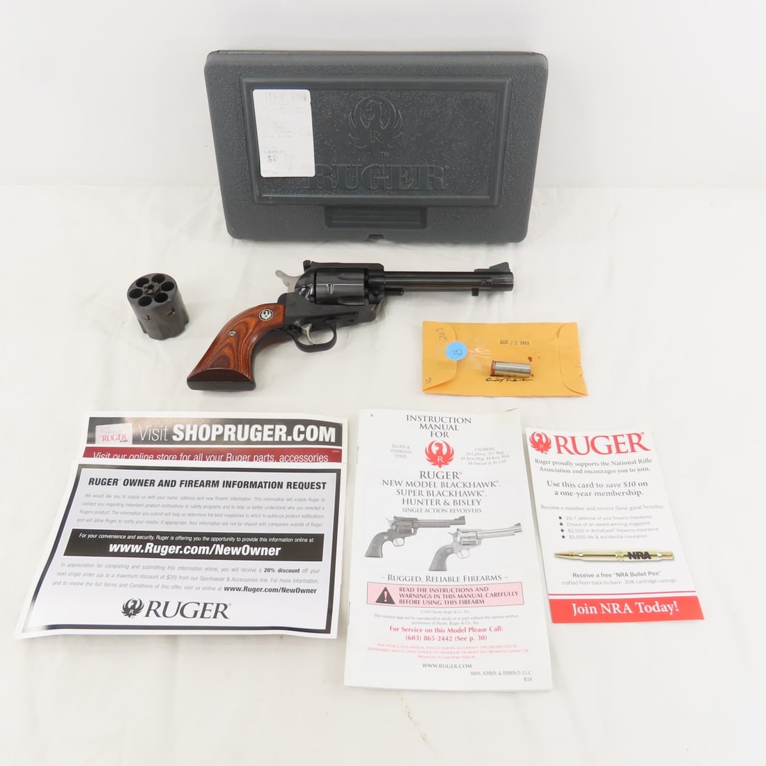 Ruger New Model Blackhawk .45 Auto Pistol: Ruger New Model Blackhawk .45 Auto Pistol - SN# 48-62263, with extra 6 round cylinder, 5 1/2" barrel, iron sights, wood grips with medallion, paperwork, test brass and case. Mfg 2013. FFL transfer req