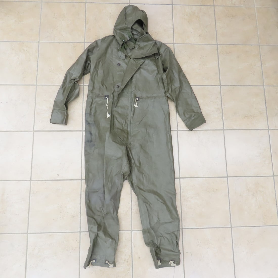 Korean War rain coveralls dated 1950: Korean War rain coveralls dated 1950 - Photos are part of description. Please ask questions and read terms & conditions before bidding.