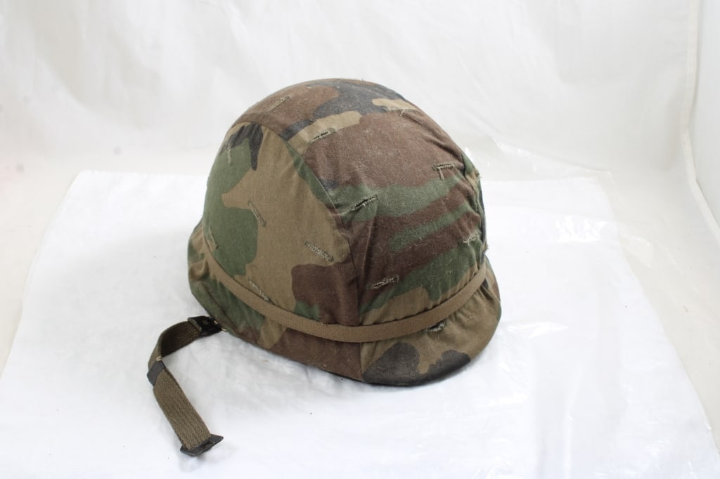 Vietnam Era Helmet w/Liner, Camo Cover Woodland: Vietnam Era Helmet w/Liner, Camo Cover Woodland - Measures 11" x 10".. Photos are part of description- Live Auctioneers only shows 20 photos per lot, if there are more you can view them on Proxibid or
