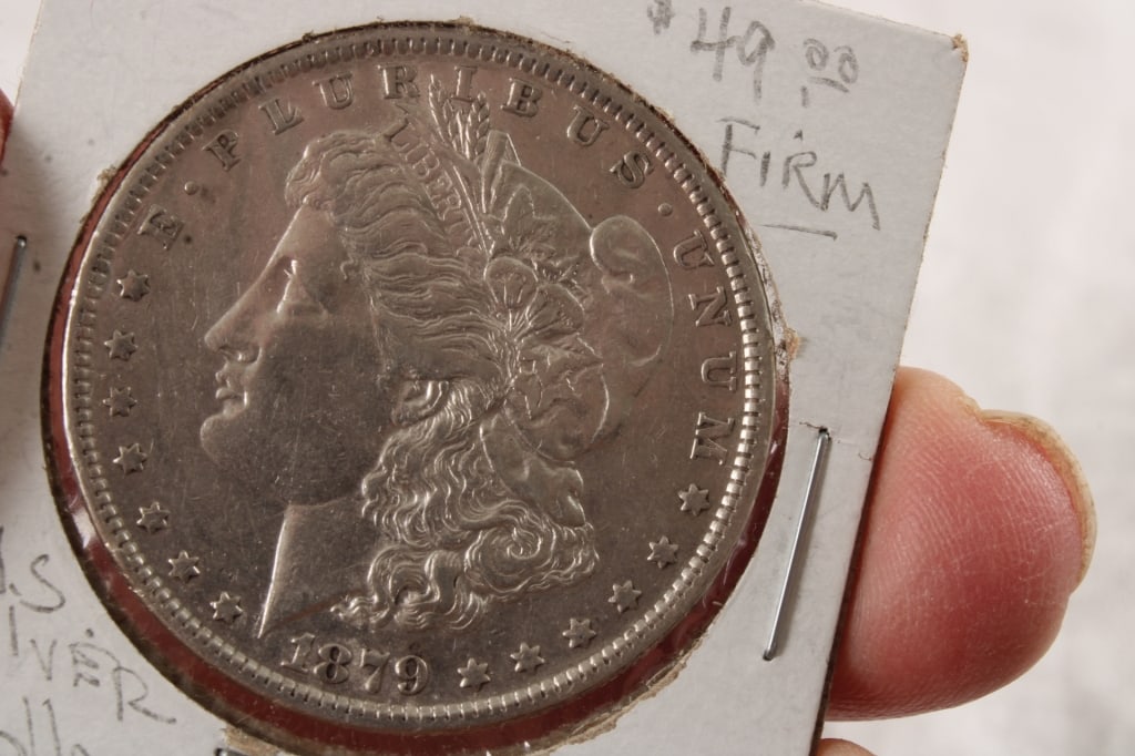 1879 Morgan Silver Dollar: 1879 Morgan Silver Dollar - . Photos are part of description- Live Auctioneers only shows 20 photos per lot, if there are more you can view them on Proxibid or bidding app. Please ask questions and re