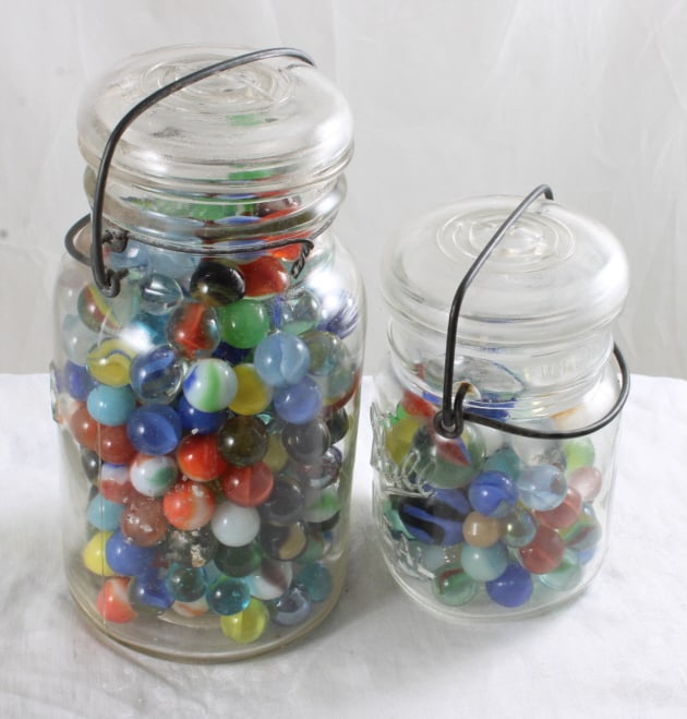 2 Fruit Jars Filled with Vintage Marbles: 2 Fruit Jars Filled with Vintage Marbles - Atlas Jar & Ball Jar. Photos are part of description- Live Auctioneers only shows 20 photos per lot, if there are more you can view them on Proxibid or biddi