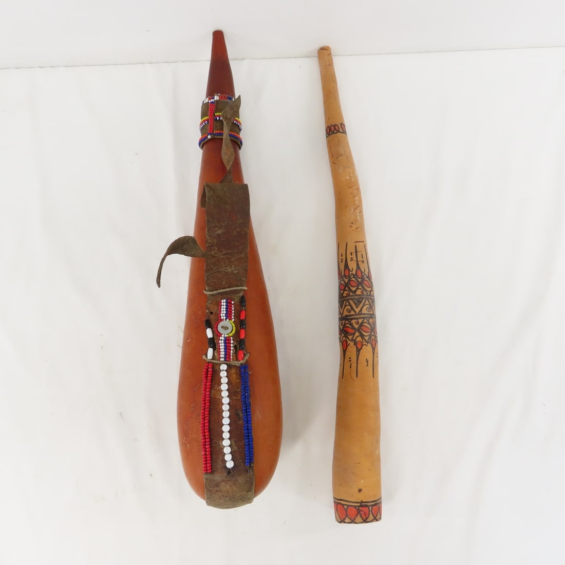 2 African Calabash Vessels, Drinking Gourds: 2 African Calabash Vessels, Drinking Gourds - 18" long, Some beads missing, Lot size: 18 x 6 x 5", 2 lbs Photos are part of lot description. Please ask questions and read terms & conditions before bid