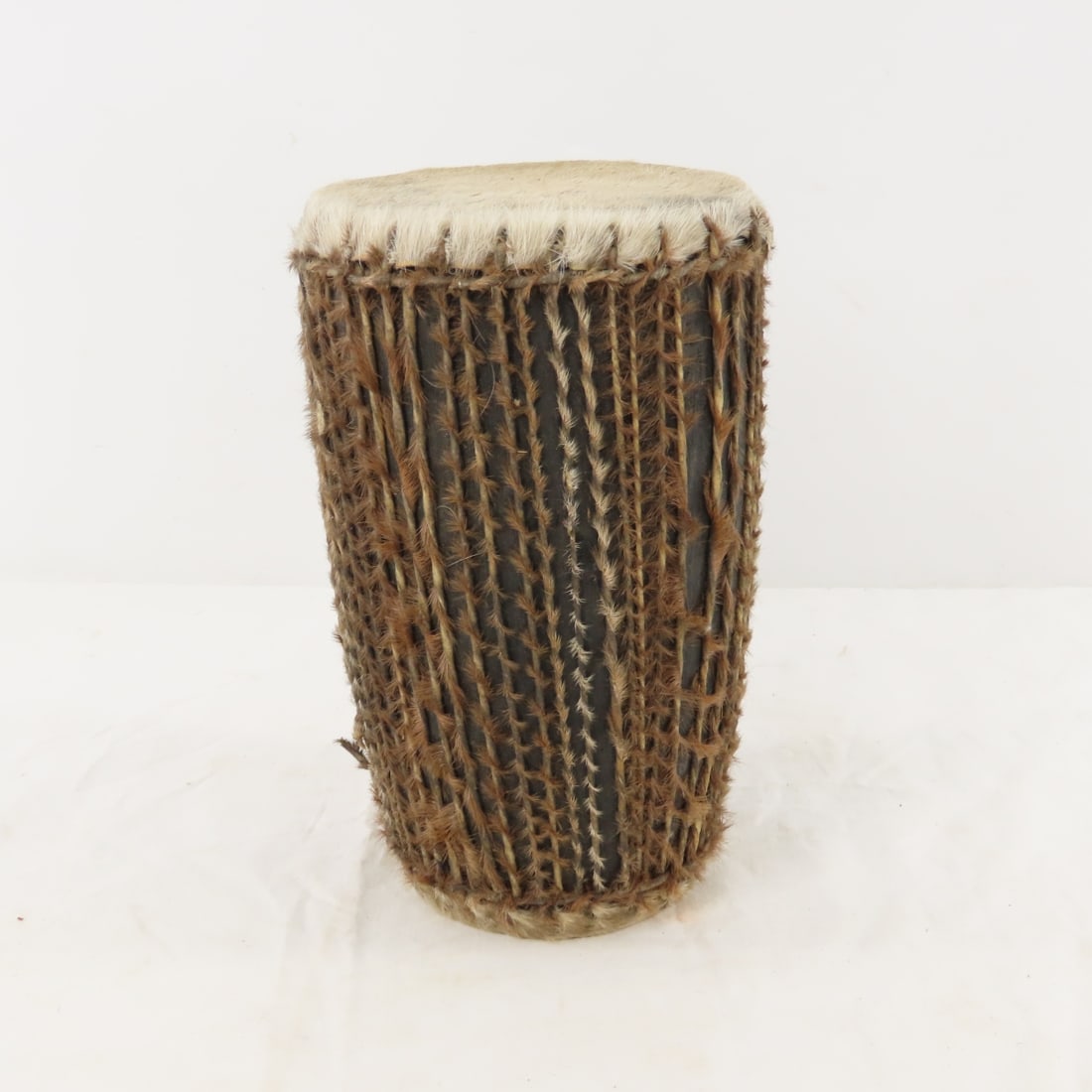 African Double-Sided Ritual Cowhide Drum: African Double-Sided Ritual Cowhide Drum - There are 3 damaged/broken strings, 8.5" tall, 5" & 4" skins, Lot size: 9 x 6 x 6", 2 lbs Photos are part of lot description. Please ask questions and read t