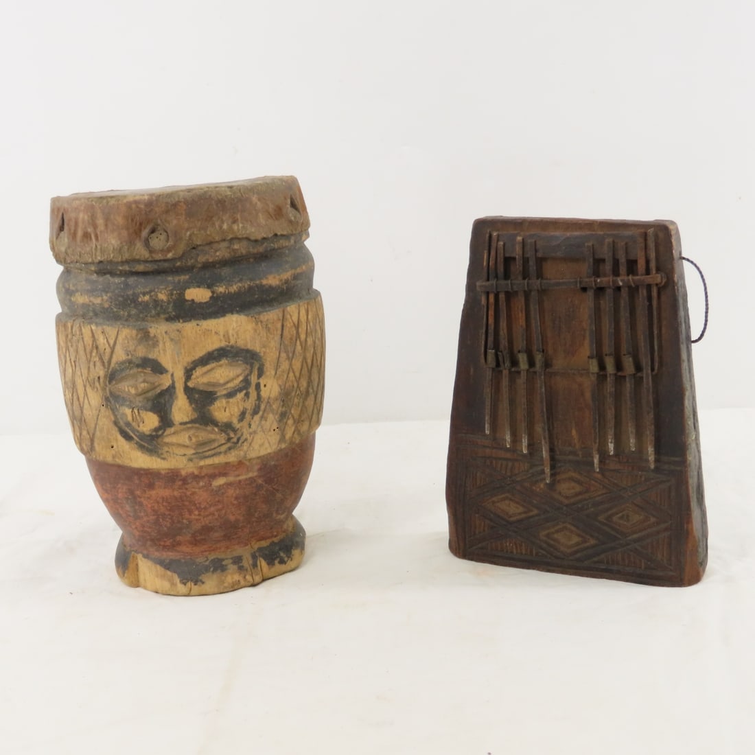 African Kalimba or Sanza Mbira Instrument & Drum: African Kalimba or Sanza Mbira Instrument & Drum - Also referred to as "Thumb Piano", Possibly missing a middle key, Drum 8" tall and has some chipping around base, Lot size: 9 x 6 x 6", 3 lbs Photos