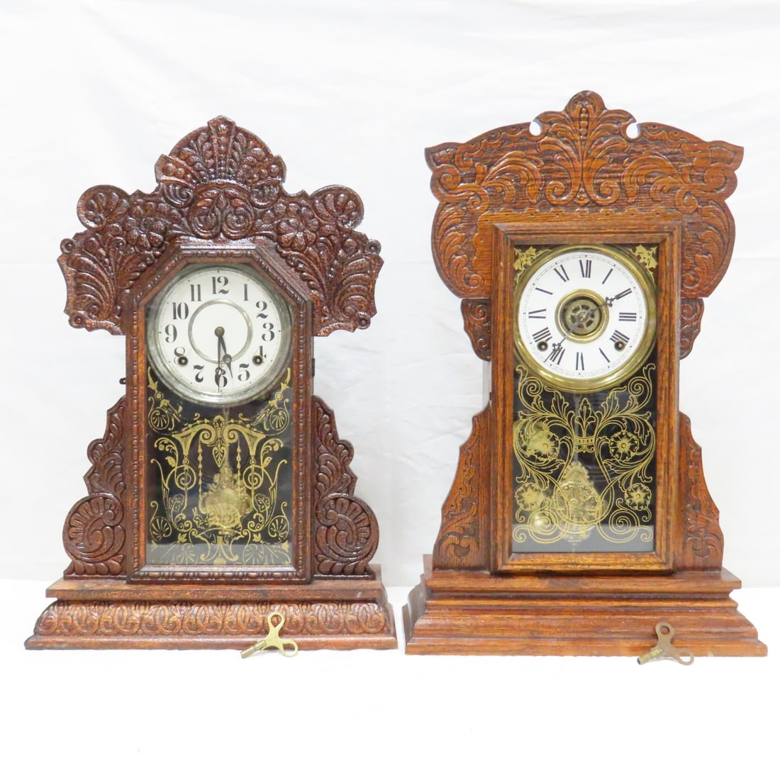 2 Antique Gingerbread Mantel Clocks, Gilbert: 2 Antique Gingerbread Mantel Clocks, Gilbert - Tested: Gilbert Capitol #43, pendulum working, chimes, keeps time. Possible Ingraham, pendulum works, chimes, uncertain if keeping time. 22" tall, both c