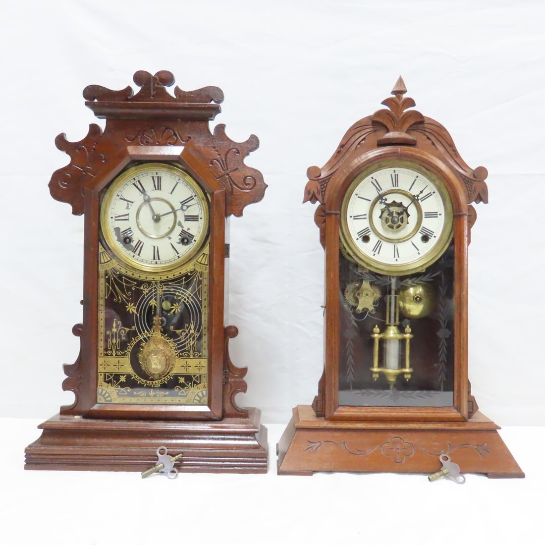 2 Antique Wood Mantel Clocks, Possibly Ansonia: 2 Antique Wood Mantel Clocks, Possibly Ansonia - Tested: Clock with decorative glass, pendulum working, chimes, seems to keep time. Other clock, mechanics are not lined up with clock face and needs ad