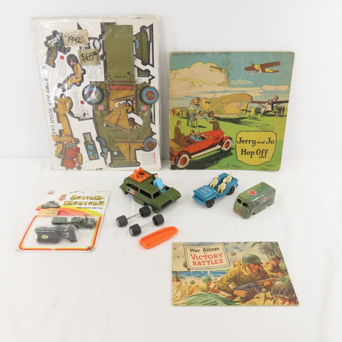 Vintage Military vehicle, toys, paper toys, books: Vintage Military vehicle, toys, paper toys, books - 1928 "Jerry and Jo hop Off " soft cover book, 1942 paper airplanes and more. Lot size: 15 x 11 x 5", 3 lbsPhotos are part of description. Please ask