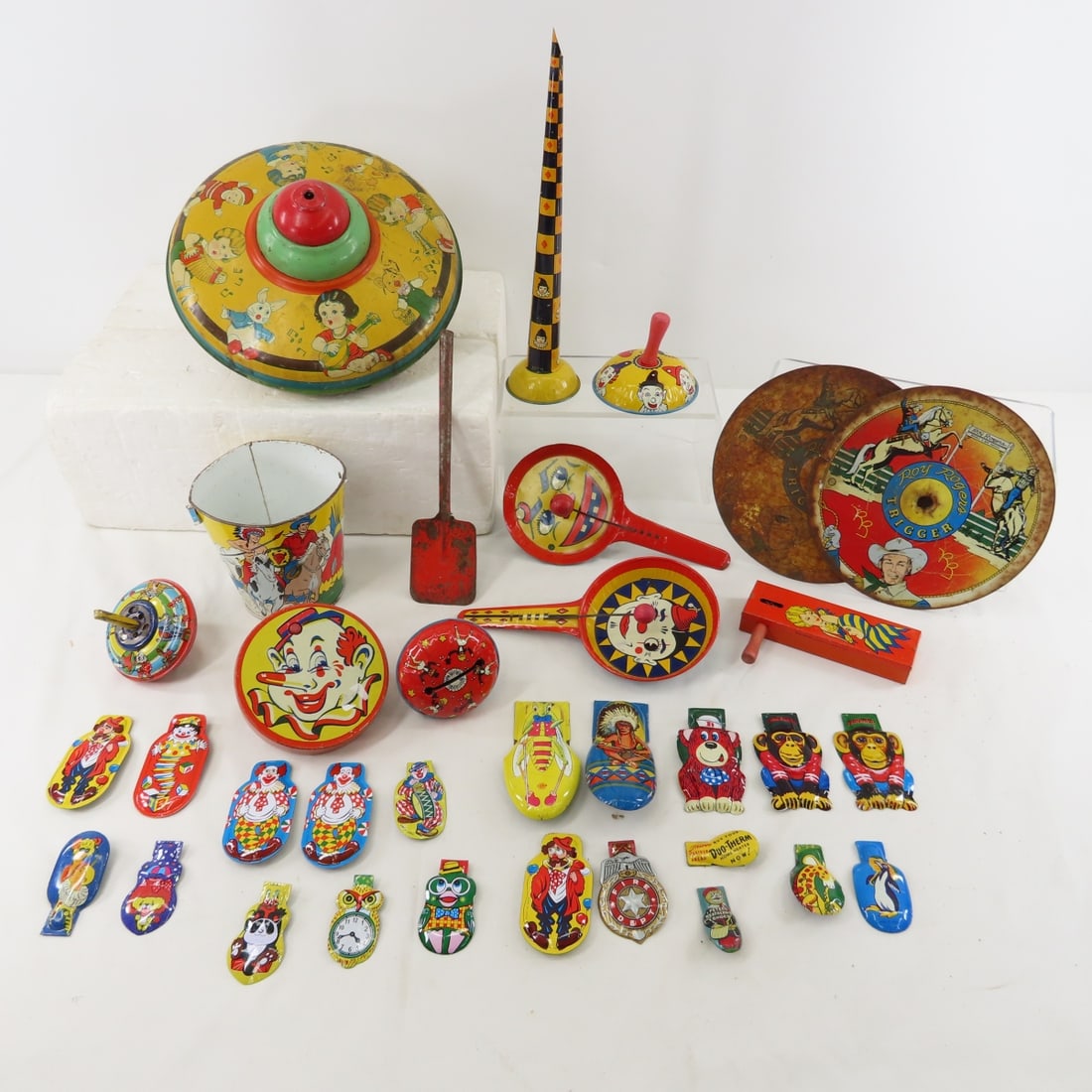 Tin noisemakers, clickers, bucket & more: Tin noisemakers, clickers, bucket & more - top has no plunger, Ohio art bucket, Kirchof noise makers. Lot size: 15 x 10 x 9", 3 LBSPhotos are part of description. Please ask questions and read terms &