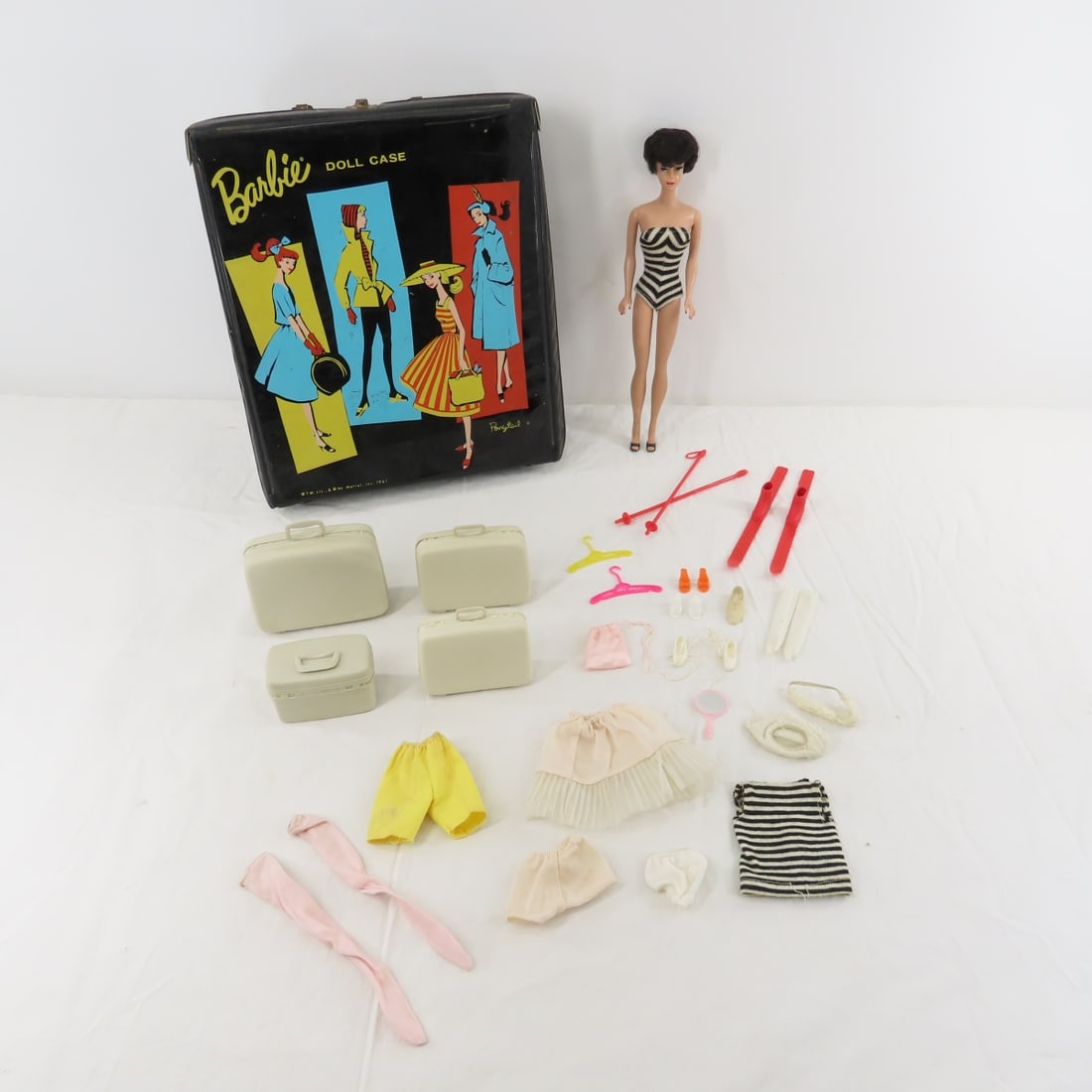 1961 Brunette Bubblecut Barbie #850 Straight Leg: 1961 Brunette Bubblecut Barbie #850 Straight Leg - Doll mark Barbie ® Pats. Pend. © MCMLVIII by Mattel Inc., waxy face and earring stains, swimsuit, shoes, broken glasses. Case, 4 piece lugg