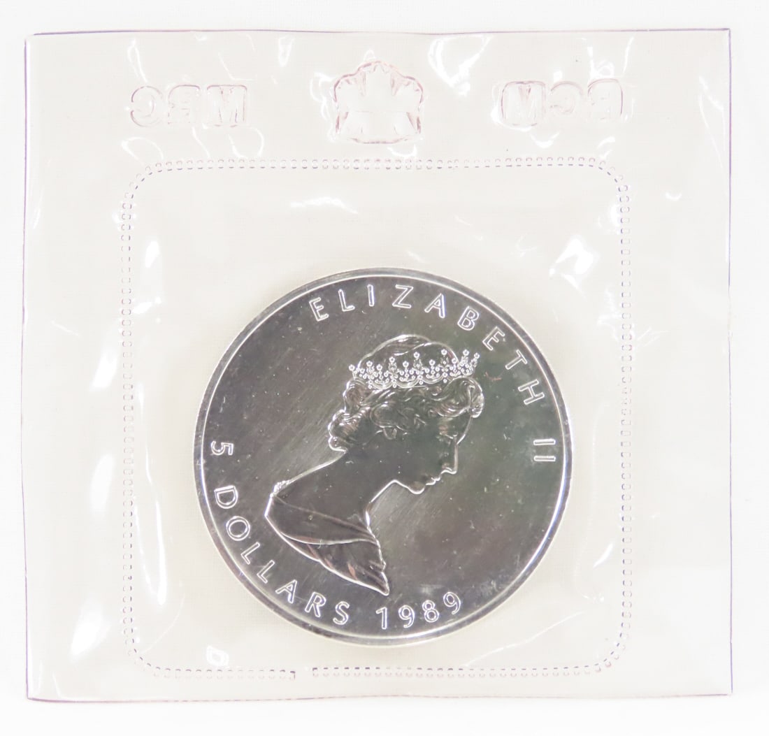 1989 $5 Canadian Silver Maple Leaf .9999 Silver: 1989 $5 Canadian Silver Maple Leaf .9999 Silver - Sealed in RCM plastic. Lot Size 2x2x1" 1lb Photos are part of description, Live Auctioneers only displays the 1st 20 photos per lot. Please ask questi