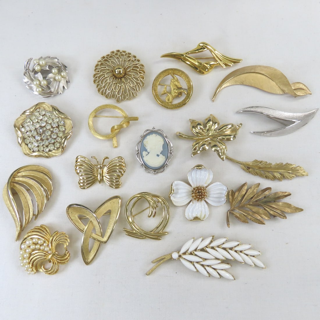 19 Signed Trifari Brooches: 19 Signed Trifari Brooches - 1 is missing some rhinestones, Lot size 6 x 6 x 6", 1 lb Photos are part of description, Live Auctioneers only displays the 1st 20 photos per lot. Please ask questions and