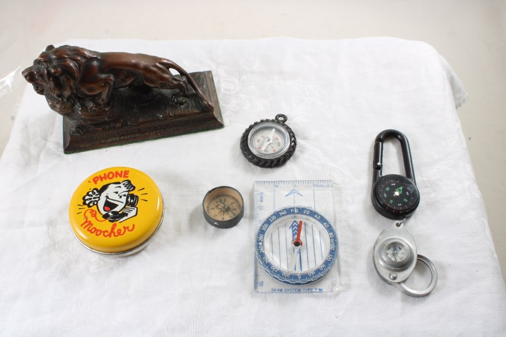Lion Paperweight, 5 Compass, Phone Moocher Bank: Lion Paperweight, 5 Compass, Phone Moocher Bank - Bronze Lion Paperweight N.W. Glass Co. Mpls. Mn., 5 Compass, 1 Tin Phone Moocher Bank. 1 1/2 Lb. Lot Size 6" x 6" x 6". Photos are part of