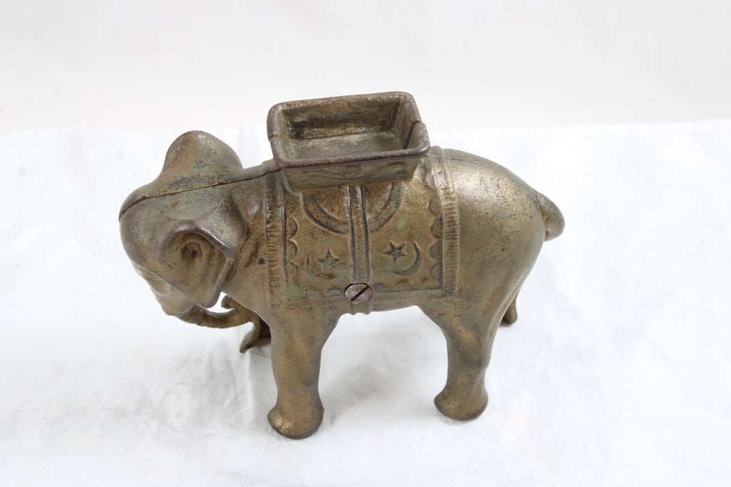 A C Williams Cast Iron Circus Elephant Bank: A C Williams Cast Iron Circus Elephant Bank - 2 Lbs. Lot Size 6" x 5" x 4". Photos are part of description (Live Auctioneers only shows up to 20). Please ask questions and read terms & conditions befo
