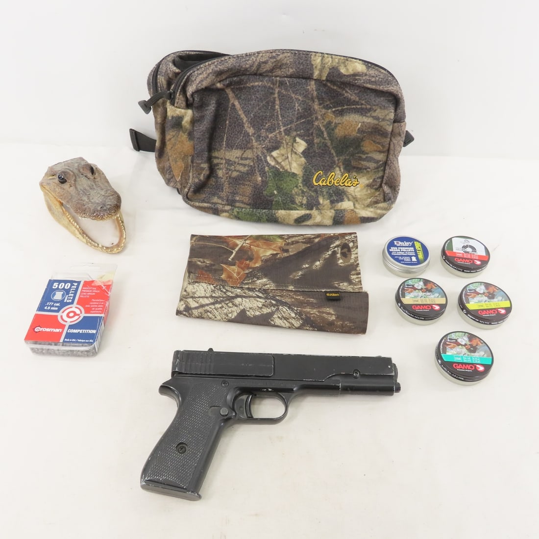 Crosman Repeater BB Pistol with BB's, Pellets: Crosman Repeater BB Pistol with BB's, Pellets - Camo bags & Small Alligator head taxidermy Photos are part of description. Live Auctioneers displays a max of 20 photos- all photos can be seen on