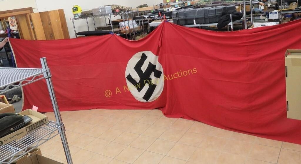 WWII German NSDAP 21' Building Banner Flag: WWII German NSDAP 21' Building Banner Flag - has tear, black swastika is printed on white circle, then sewn on to red backing, double sided, some stains and holes measures approx 21x6 feet. Lot