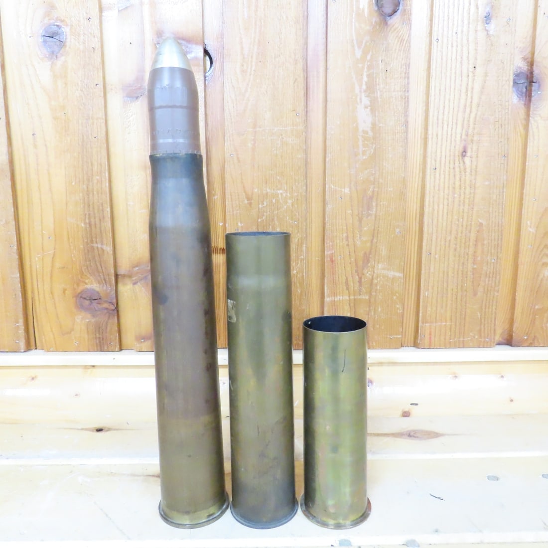 3 WWII 75MM & 57MM Brass Cartridge Casings: 3 WWII 75MM & 57MM Brass Cartridge Casings - 2 75MM, 1 57MM. 75MM Mod 28 54 03, 75MM GUN LOT 2002 E.M.C., 57MM M23A2 1943. Lot Size: 23 x 7 x 7", 10 lbs Photos are part of description. Live Auctioneer