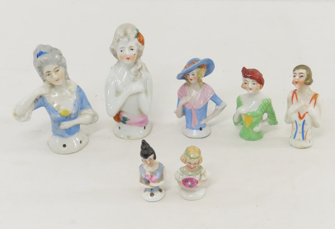 7 Germany, Japan & Other Porcelain Half Dolls: 7 Germany, Japan & Other Porcelain Half Dolls - 2 miniature 1.5"- 1 marked Germany. 3 are 2.5", 2 of them are marked Japan, the 3rd in blue hat is marked 1507 and stamped Foreign. 2 are 3.5" and