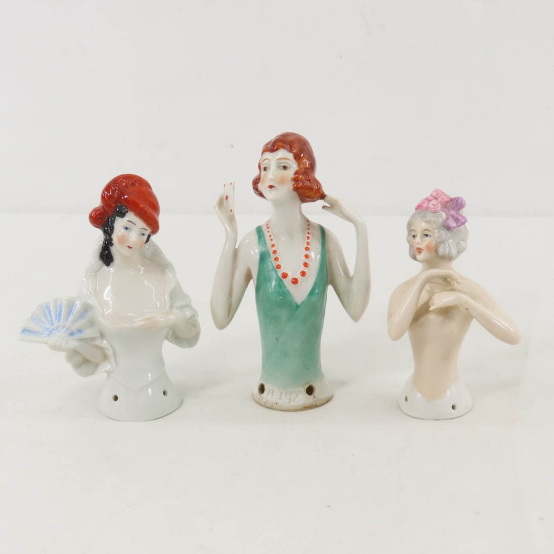 3 German Numbered Porcelain Half Dolls: 3 German Numbered Porcelain Half Dolls - ca. 1879-1886. Carl Schneider 15278 nude, A192 red head playing cards, and 8037 in hat with fan. Lot size: 6x6x6", 1 lb Photos are part of description.