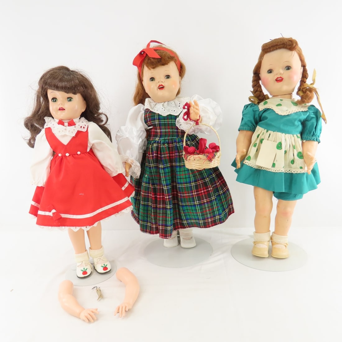 2 IMPCO Saucy Walker Dolls & Other Plastic Doll: 2 IMPCO Saucy Walker Dolls & Other Plastic Doll - 20" Saucy in plaid dress walks great, other has crack around neck so head does not turn correctly and her eyelids are going white. unmarked 18:"