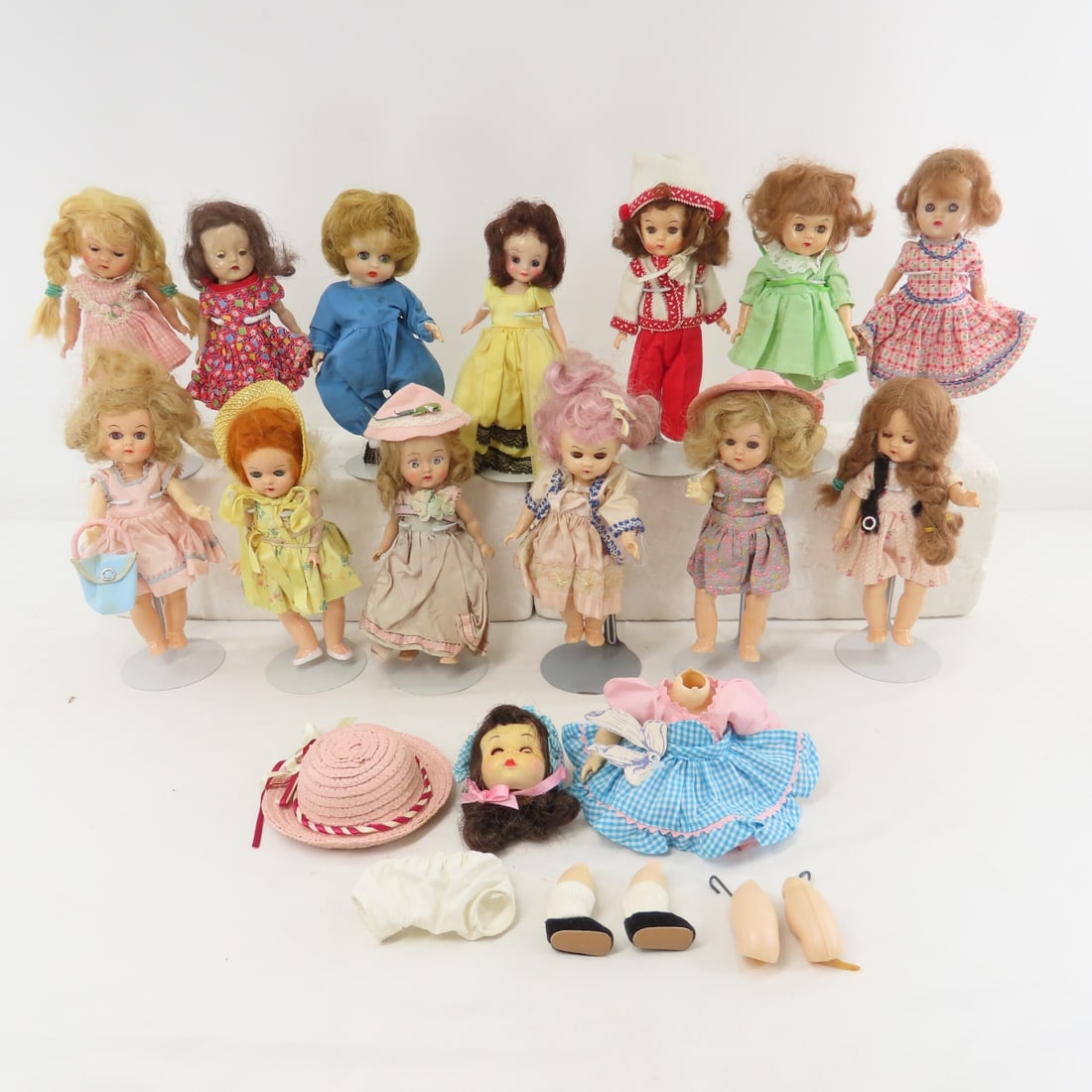 Betsy McCall & 11 Other 8" 1950's Plastic Dolls: Betsy McCall & 11 Other 8" 1950's Plastic Dolls - Betsy McCall in non original yellow dress, 5 walker & 6 other dolls all are unmarked - 1 has arms that are unstrung, last doll in blue outfit has