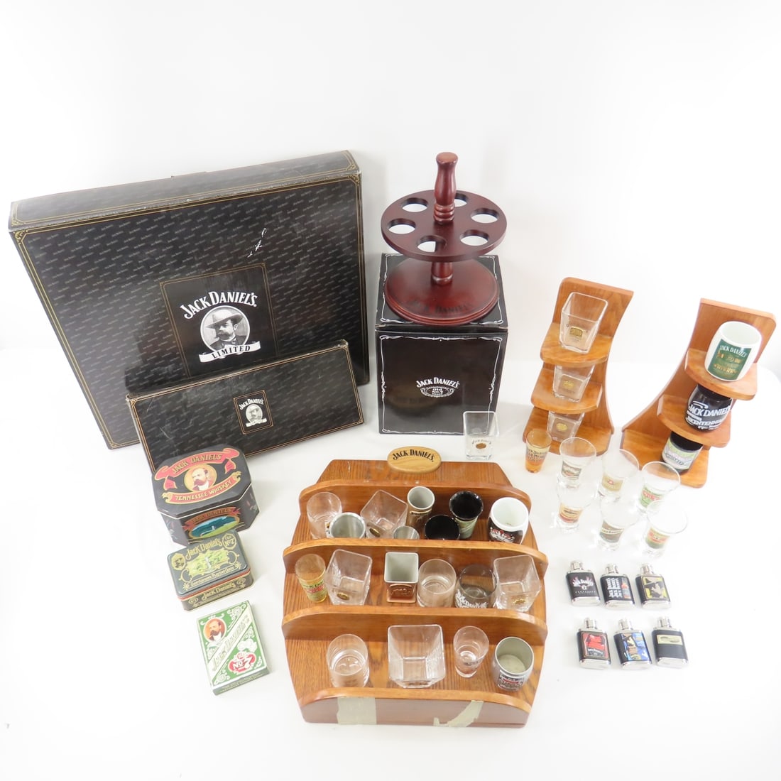 Collection Of Jack Daniel's Shot Glasses & Display: Collection Of Jack Daniel's Shot Glasses & Display - Jack Daniel's Shot Glasses, Wood Display Racks, Tins, Playing Cards. Lot Size: 20 x 16 x 16", 23 lbs Photos are part of description. (Live Auctione