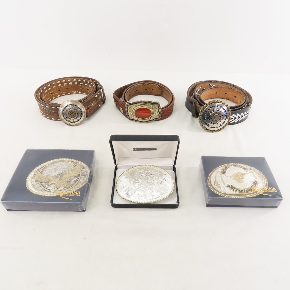 3 Montana Silversmiths & 3 Other Buckles w/Belts: 3 Montana Silversmiths & 3 Other Buckles w/Belts - 38" belt with agate buckle, 44" Dakota Belt Co black belt with accents & Mexican style buckle, 44" brown embossed belt with Mexican style buckle.