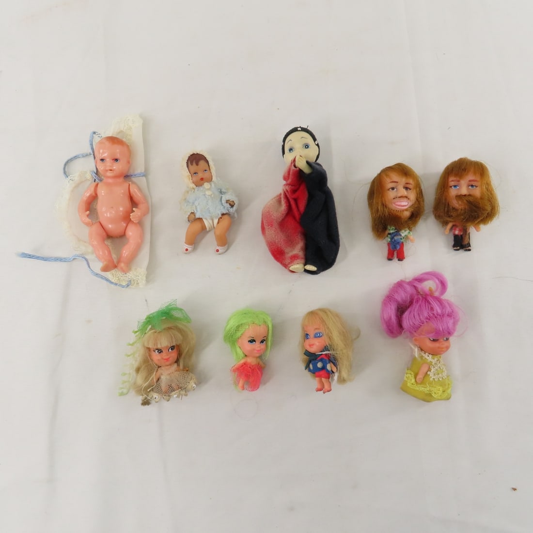 Liddle Kiddles & Other Vintage Dolls: Liddle Kiddles & Other Vintage Dolls - 4 Liddle Kiddles, 2 Keychain bearded guys, and more. All have been displayed- may not be complete or all original. Lot size: 8x8x8", .6lbs Photos are part of