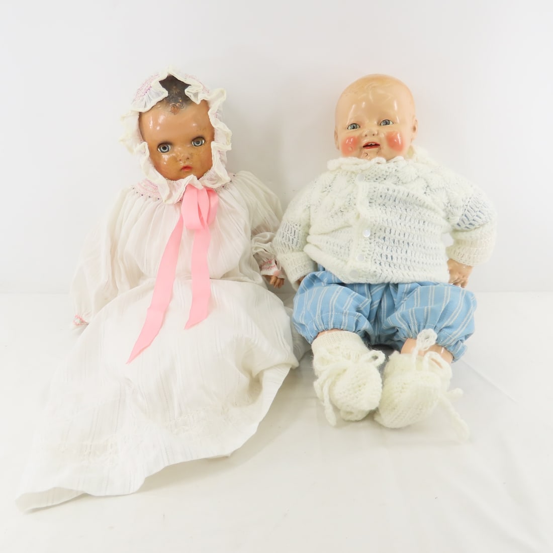 2 Antique Horsman Composition & Cloth Baby Dolls: 2 Antique Horsman Composition & Cloth Baby Dolls - Both have compo heads, arms and legs with cloth body, sleep eyes, molded hair. 1) 20" no lashes, open mouth with teeth, damage on face, minor