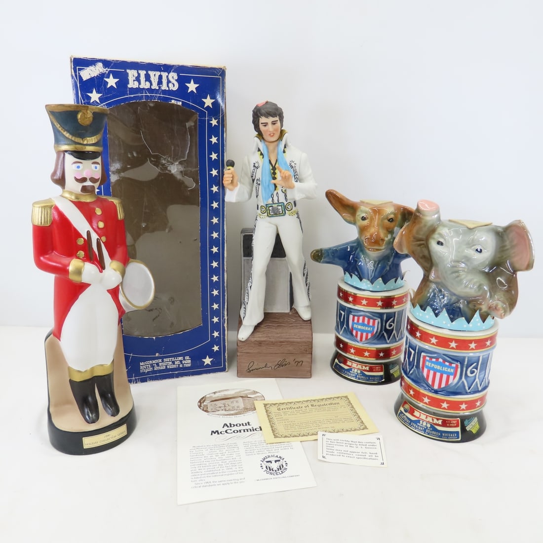 1976 Beam DFL & GOP Decanters, Elvis & Nutcracker: 1976 Beam DFL & GOP Decanters, Elvis & Nutcracker - GOP elephant and nutcracker are sealed. McCormick Elvis is in box which has some damage. Lot size; 18 x15 x13", 16 lbs. Photos are part of