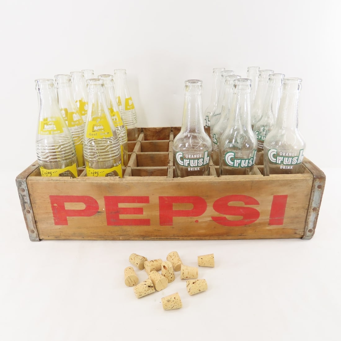 Vintage Wood Pepsi Crate & 16 Soda Bottles: Vintage Wood Pepsi Crate & 16 Soda Bottles - Wood Pepsi Crate holds 24 Bottles. There are 9 Orange Crush Bottles & 7 Mason's Root Beer Bottles. Lot Size: 19 x 12 x 10", 21 lbs Photos are part of descr