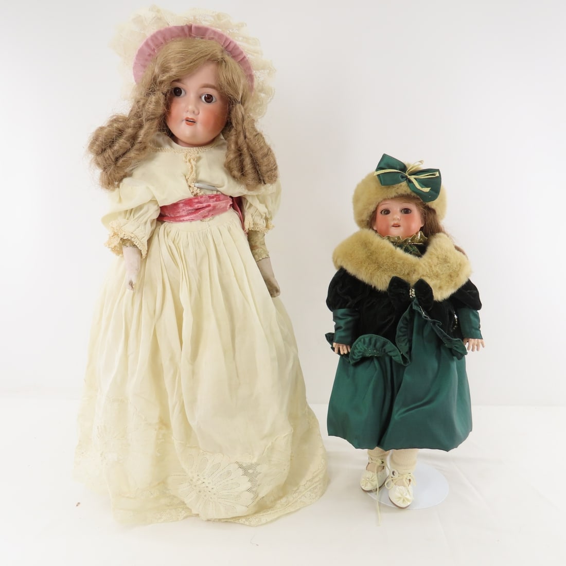 2 Antique A. Marseilles Floradora Dolls: 2 Antique A. Marseilles Floradora Dolls - 1) 23" bisque socket head marked Floradora A 3 M with fixed eyes, painted lashes, and open mouth with teeth, no pate, kid leather body with cloth lower legs.