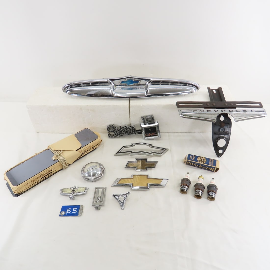 Vintage Car Emblems, Logos, Parts and More: Vintage Car Emblems, Logos, Parts and More - Chevy & GM emblems, Stack of NOS rear view mirror glass. LOT SIZE 22X10X8" 10 LB Photos are part of description. (Live Auctioneers only shows a max of 20