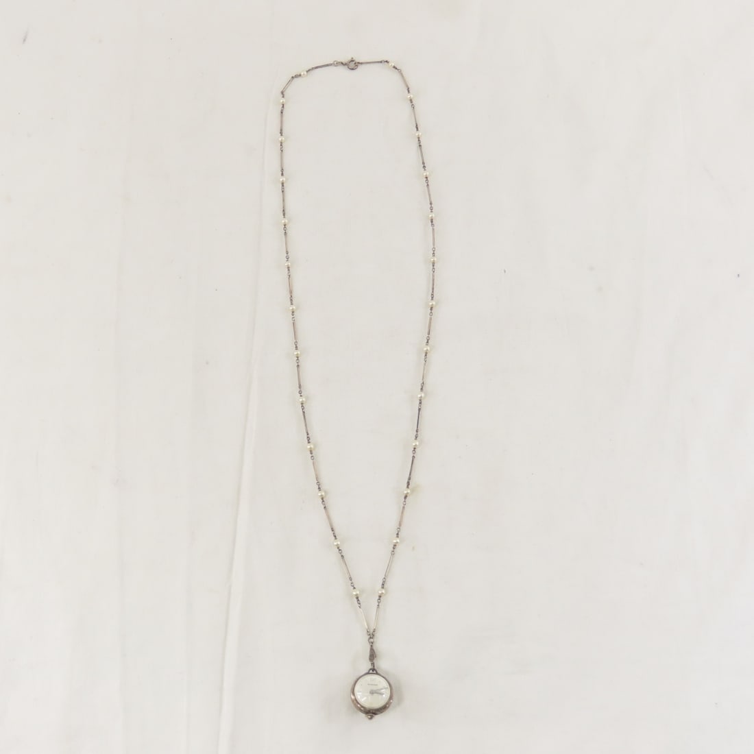 Bucherer Crystal Ball Watch on 800 Silver Chain: Bucherer Crystal Ball Watch on 800 Silver Chain - Bucherer 17 jewel clear skeleton back pendant watch- working, on a 800 silver chain with pearl accents. Working. 18.2 grams total. Lot size: