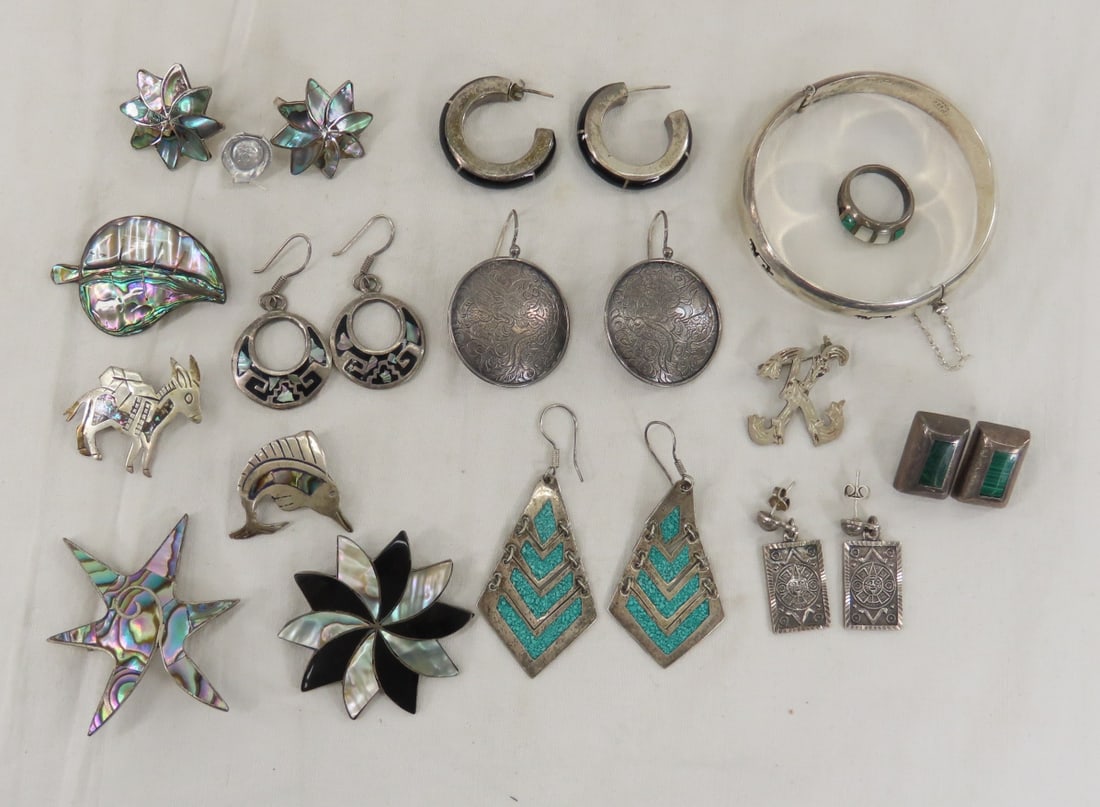 125+ grams Sterling Silver Mexico Jewelry: 125+ grams Sterling Silver Mexico Jewelry - many inlaid with Mother of pearl or malachite, many marked Taxco. lot size: 4x4x5", 4 oz Photos are part of description. (Live Auctioneers only shows a