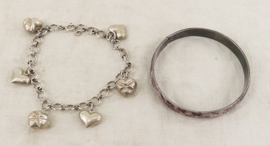 2 Sterling Silver Bracelets 41.9 gtw: 2 Sterling Silver Bracelets 41.9 gtw - hinged bangle marked 925, and 925 NF heart charm bracelet. Lot size: 3x3x3", 1 lb Photos are part of description. (Live Auctioneers only shows a max of 20 photos