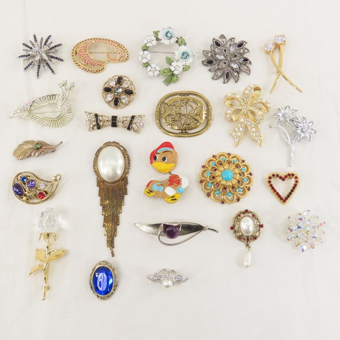 Swarovski and 23 Other Modern Brooches: Swarovski and 23 Other Modern Brooches - Lot size: 10x8x6", 1 lb Photos are part of description. (Live Auctioneers only shows a max of 20 photos). Please ask questions and read terms & conditions