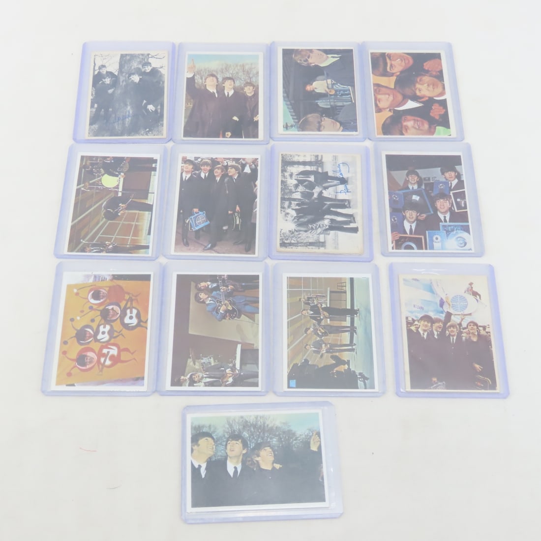 13 1964 Topps Beatles Cards: 13 1964 Topps Beatles Cards - LOT SIZE 4X4X4" 1 LB Photos are part of description. (Live Auctioneers only shows a max of 20 photos). Please ask questions and read terms & conditions before bidding. 