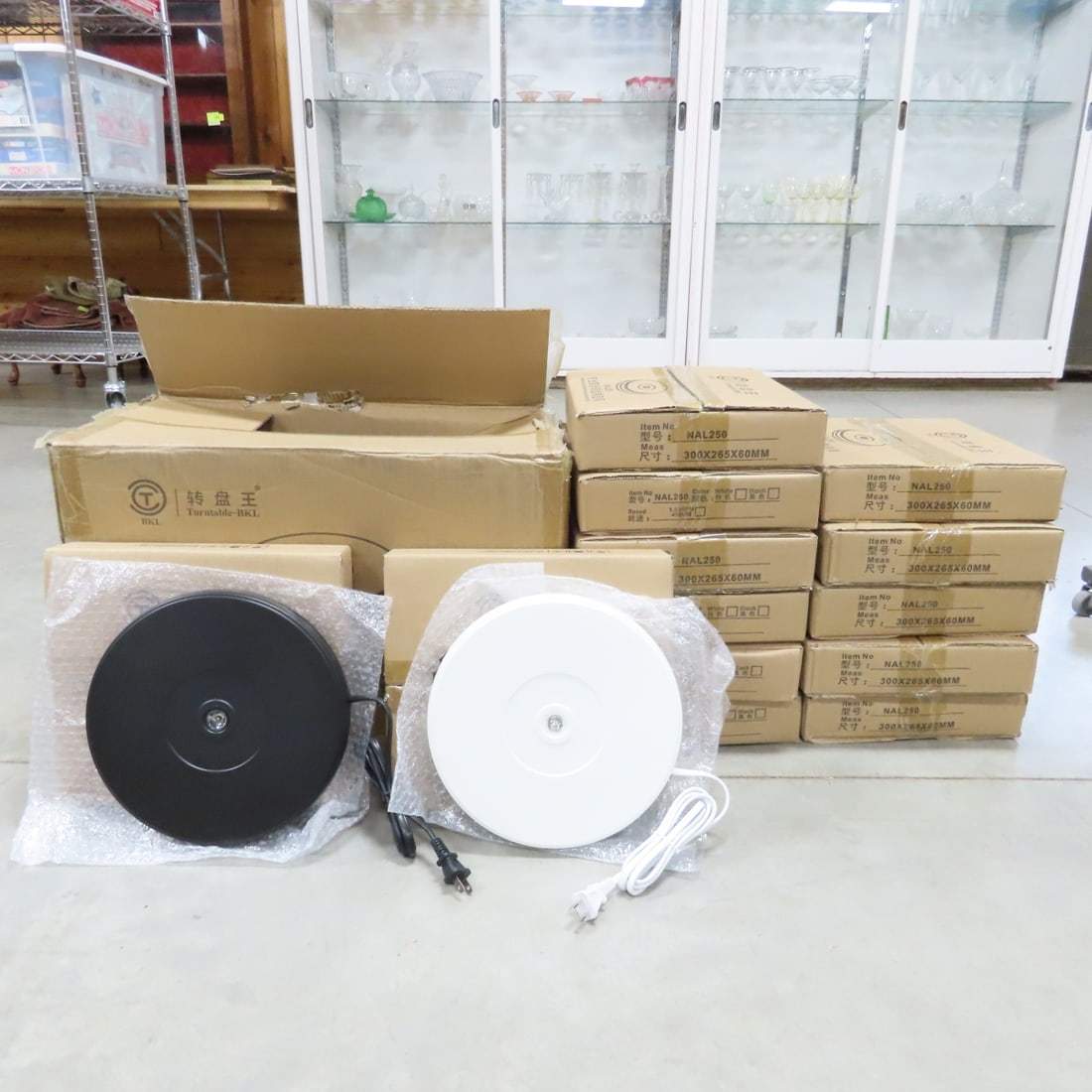 13 Mixed NAL250 Rotating 10" Display Stand w/LED: 13 Mixed NAL250 Rotating 10" Display Stand w/LED - 7 Black, 6 White, New in Original Packaging, Steady Rotation, LED Light, Up to 20 lb Load Capacity. Lot Size: 22 x 13 x 21", 30 lbs Photos are