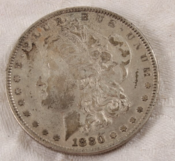 1880 Morgan Silver Dollar: 1880 Morgan Silver Dollar - Lot Size 3" x 2" x 1". 1 Lb. Photos are part of description (Live Auctioneers on displays a max of 20 photos -check other polatforms for all photos). Please ask questions
