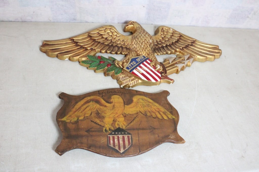 2 Eagle Shield Arrows Wall Plaques: 2 Eagle Shield Arrows Wall Plaques - Plaster Bicentennial Plaque 31" x 14" & Wood Plaque 15.5" x 10.5". Lot Size 31" x 14" x 8". 11 Lbs. Photos are part of description (Live Auctioneers on