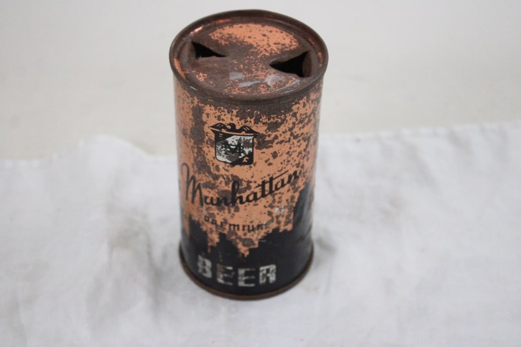 Manhattan Premium Flat Top Beer Can: Manhattan Premium Flat Top Beer Can - Some Rust. Lot Size 5" x 3" x 3". 1 Lb. Photos are part of description (Live Auctioneers on displays a max of 20 photos -check other polatforms for all