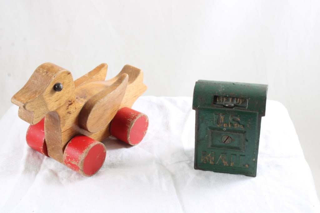 Folk Art Duck Toy & Cast Iron Mail Box Bank: Folk Art Duck Toy & Cast Iron Mail Box Bank - Wood Duck Folk Art Pull Toy and Cast Iron 4" Mail Box Bank. Lot Size 6" x 8" x 6". 2 Lbs. Photos are part of description (Live Auctioneers on