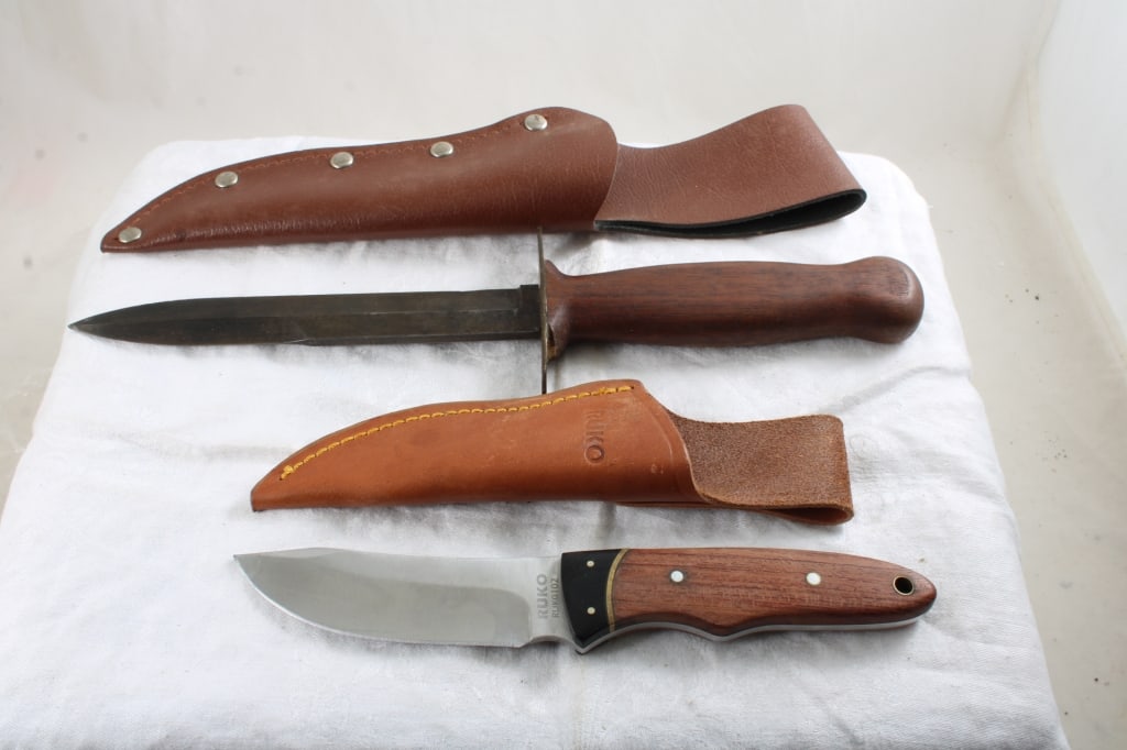 2 Fixed Blade Knives with Sheaths: 2 Fixed Blade Knives with Sheaths - Ruko Skinning Knife and Modified Bayonet Dagger. Lot Size 13" x 3" x 3". 1 Lb. Photos are part of description (Live Auctioneers on displays a max of 20 photos