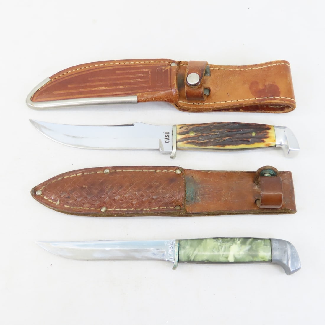 2 Antique 1930's Case Fixed Blade Knives: 2 Antique 1930's Case Fixed Blade Knives - Stag handle with fixed 5" blade is 9" OAL with Case sheath. And green pearl handle with 4.25" fixed blade is 8" OAL in unmarked sheath. Both have been sharpe