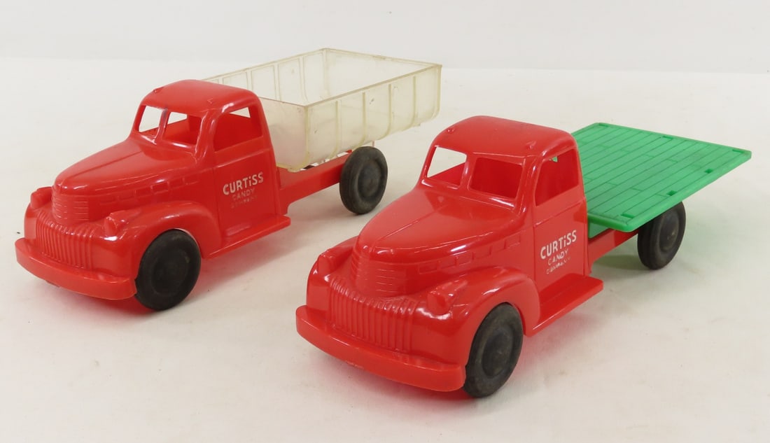 2 Curtiss Candy Plastic Trucks: 2 Curtiss Candy Plastic Trucks - Lot Size 12x8x4" 1 LB All information and photos are intended to be as accurate as possible, but errors are possible. No item may be returned or refused based on this 