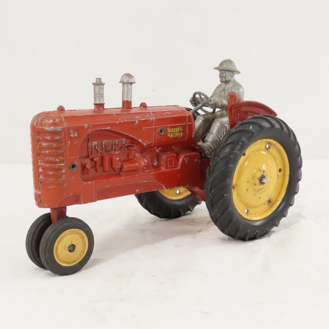 1950's SLIK Massey-Harris 44 Tractor w/ Driver: 1950's SLIK Massey-Harris 44 Tractor w/ Driver - 1/16 diecast, LOT SIZE: 8x5x6" 1 LBAll information and photos, which are part of the description) are intended to be as accurate as possible, but