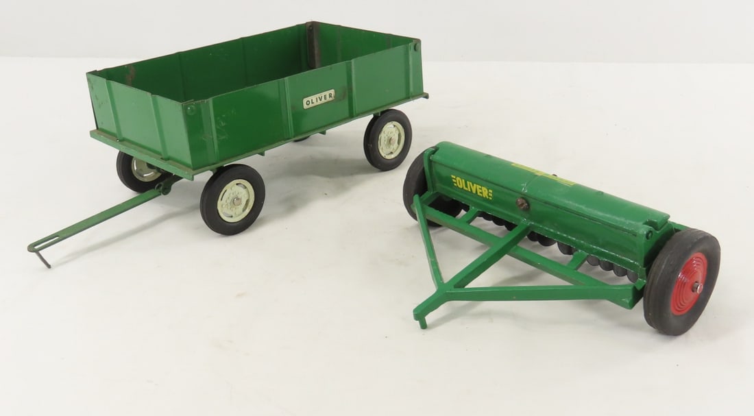 SLIK Oliver Superior Grain Drill & ERTL Wagon: SLIK Oliver Superior Grain Drill & ERTL Wagon - grain drill stamped 9837 is diecast and wagon is pressed metal, LOT SIZE: 6x8x5" 2 LBS All information and photos, which are part of the description)